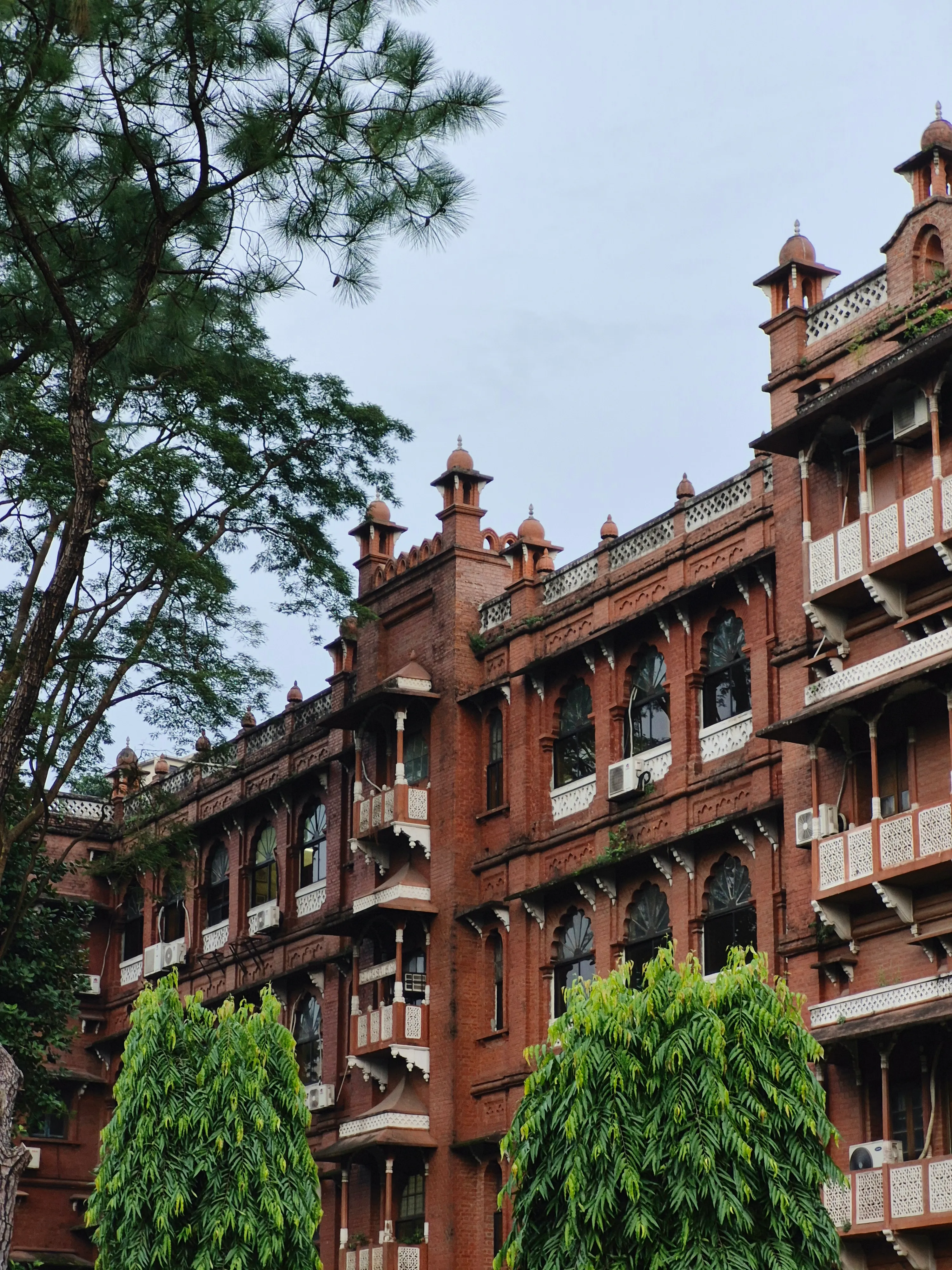 Elegant red brick architecture surrounded by lush greenery and trees